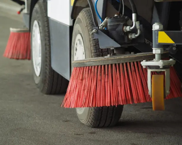 Wheels and Tires: The image shows the tires of a vehicle designed for street cleaning.